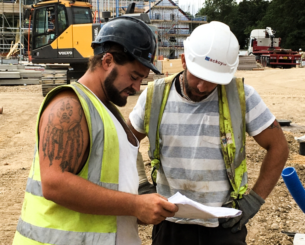 Mackoy Groundworks Operatives Studying Plans on Site